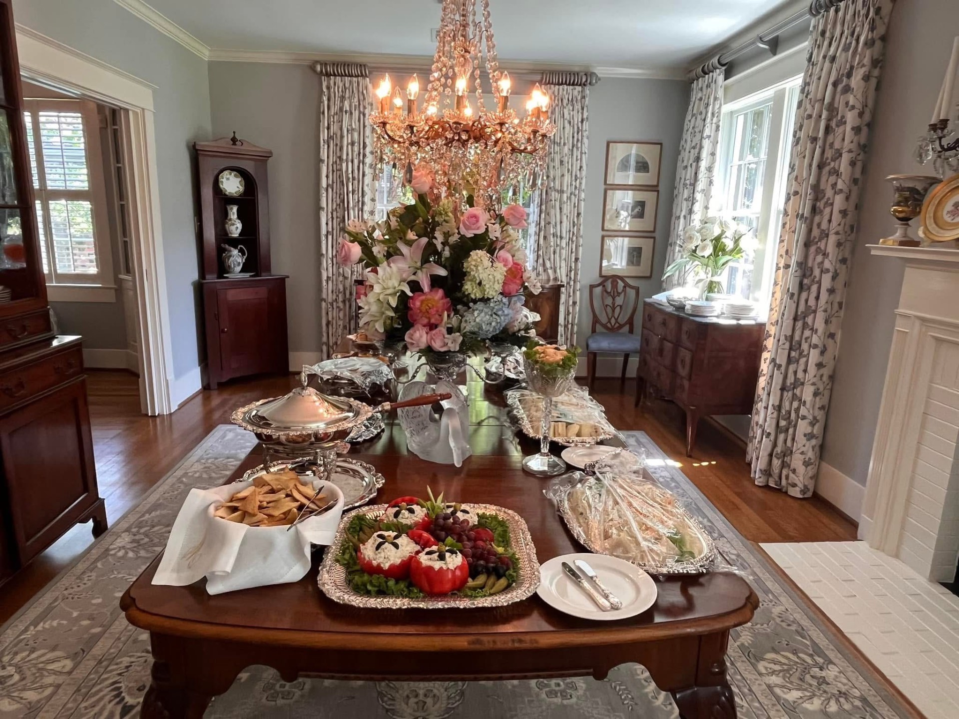 Home catering setup with sandwich trays and florals